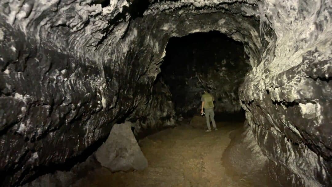 Trey standing in the left cave at Kaumana Caves