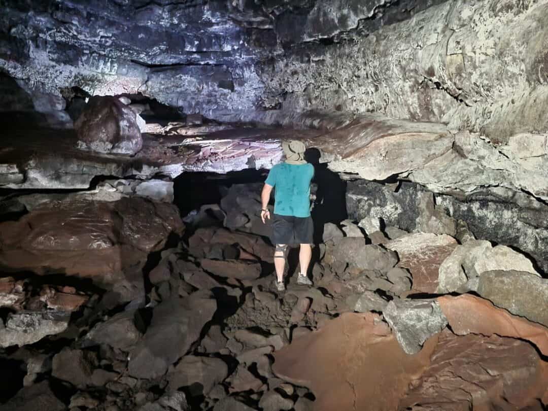 Man exploring Kaumana Caves Lava Tube