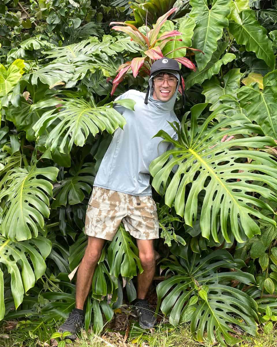 Trey in a monstera bush in Hawaii