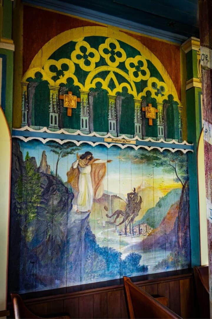 The Painted Church in Kona Is Straight Out of a Fairytale 3 "Temptation of Jesus" mural painted on the wall of Saint Benedict's Painted Church