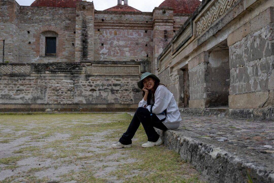 Chloe sitting inside of Mitla ruins Grupo Del Norte