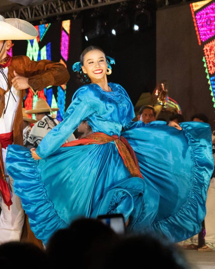 Why You Need to Visit Oaxaca: Mexico’s Cultural and Culinary Gem 15 Girl dancing with blue dress at Michoacan festival in Oaxaca