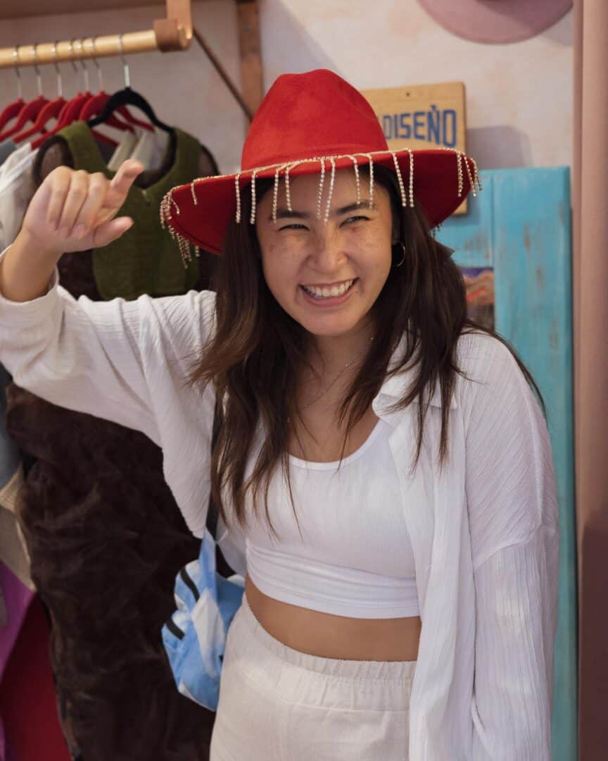 Why You Need to Visit Oaxaca: Mexico’s Cultural and Culinary Gem 18 Chloe trying on a fancy hat in a Oaxacan boutique store