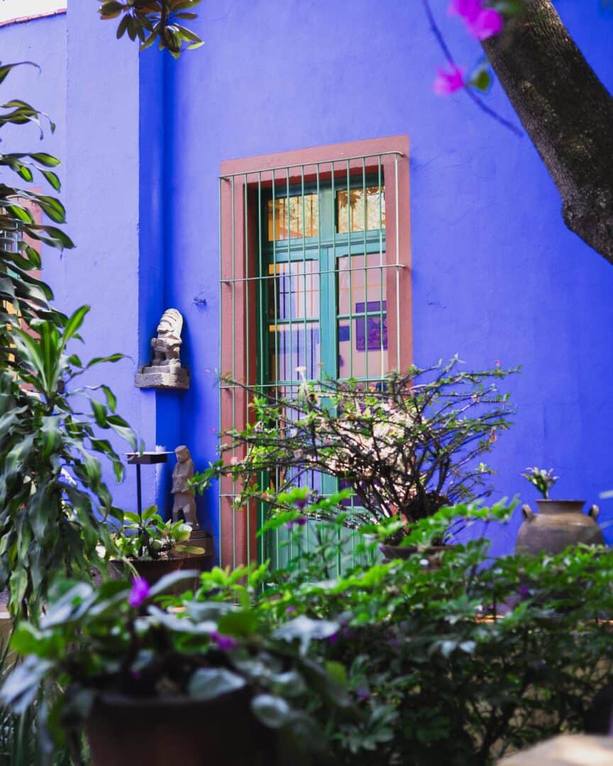 A blue door in the garden of the Frida Kahlo Museum in Mexico City