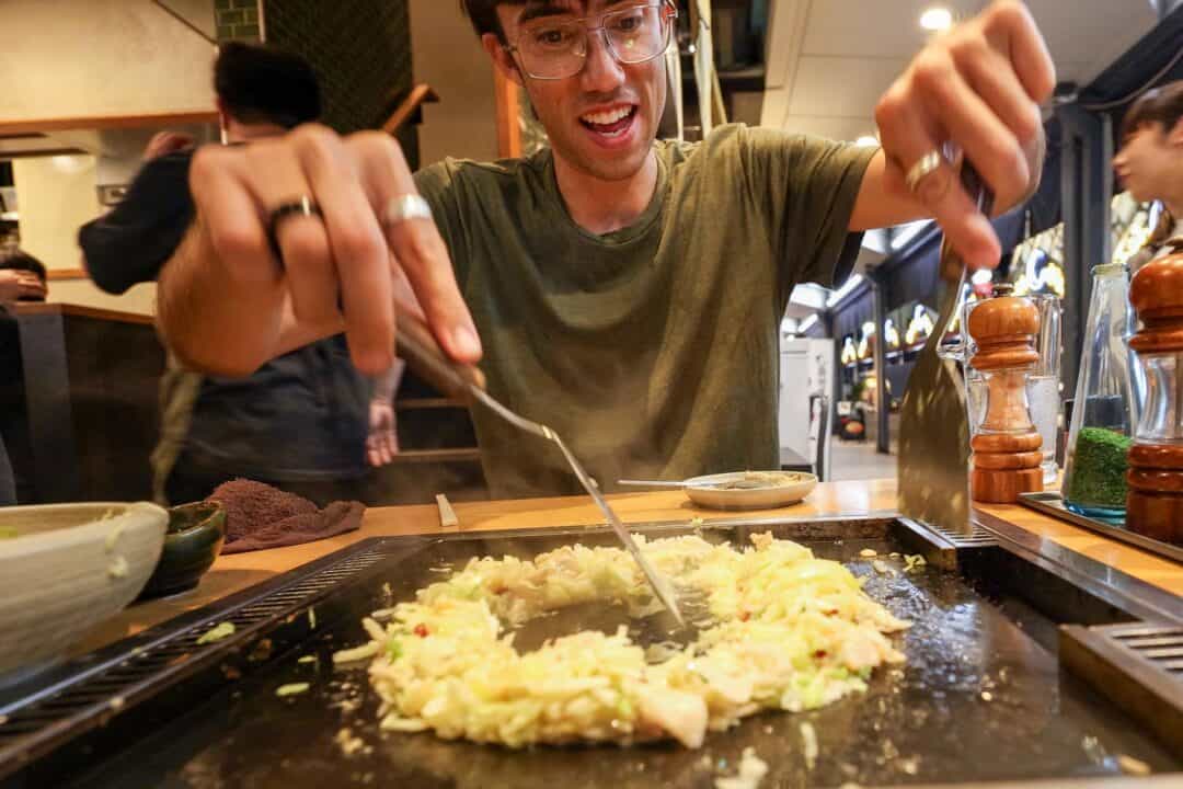 Trey trying his hand at making monjayaki in Tsukishima Tokyo