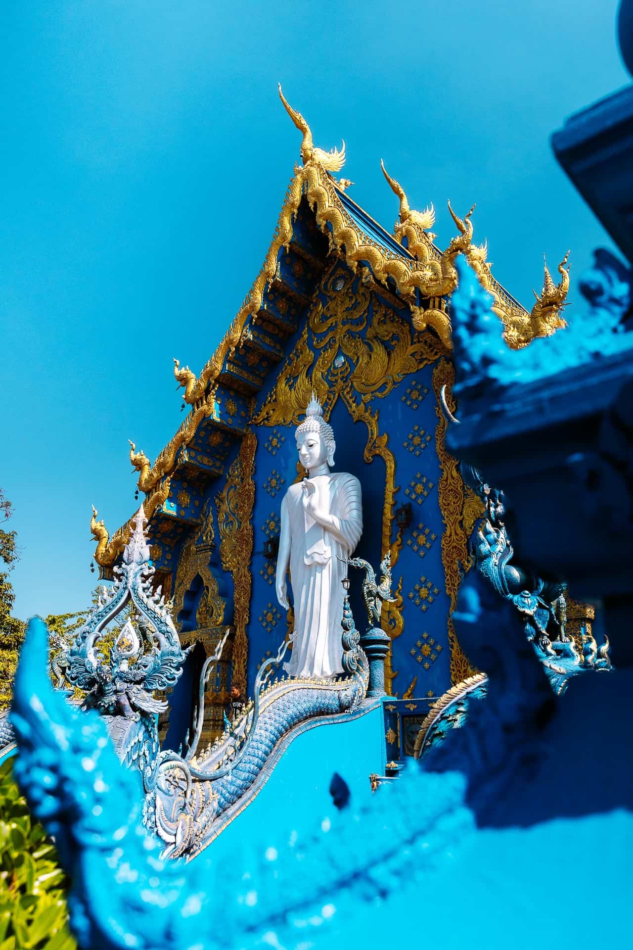 Standing White Buddha behind Wat Rong Suea Ten Blue Temple