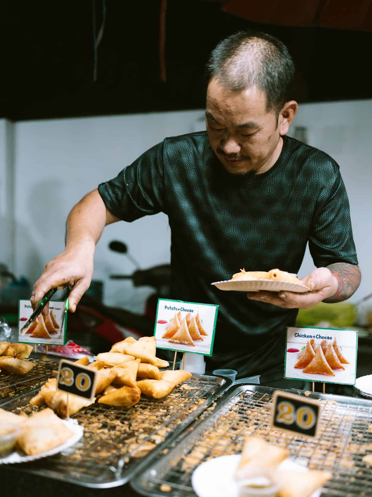 Man serving food at Pai Night Market