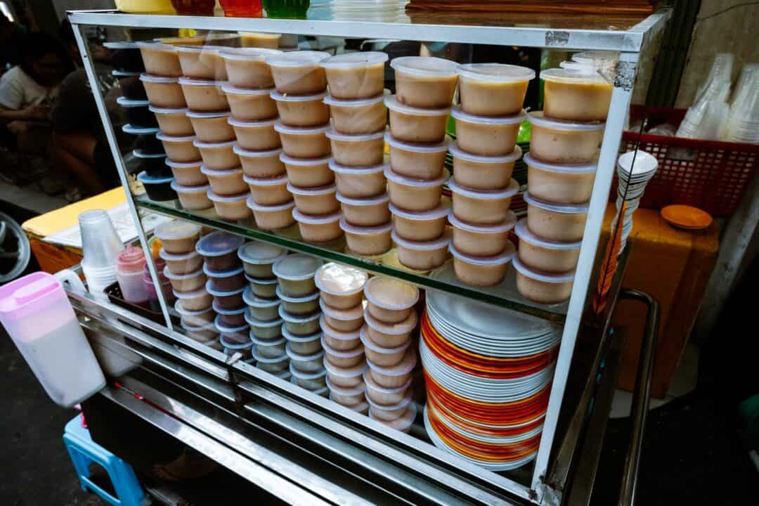 Flans stacked up on a street food cart
