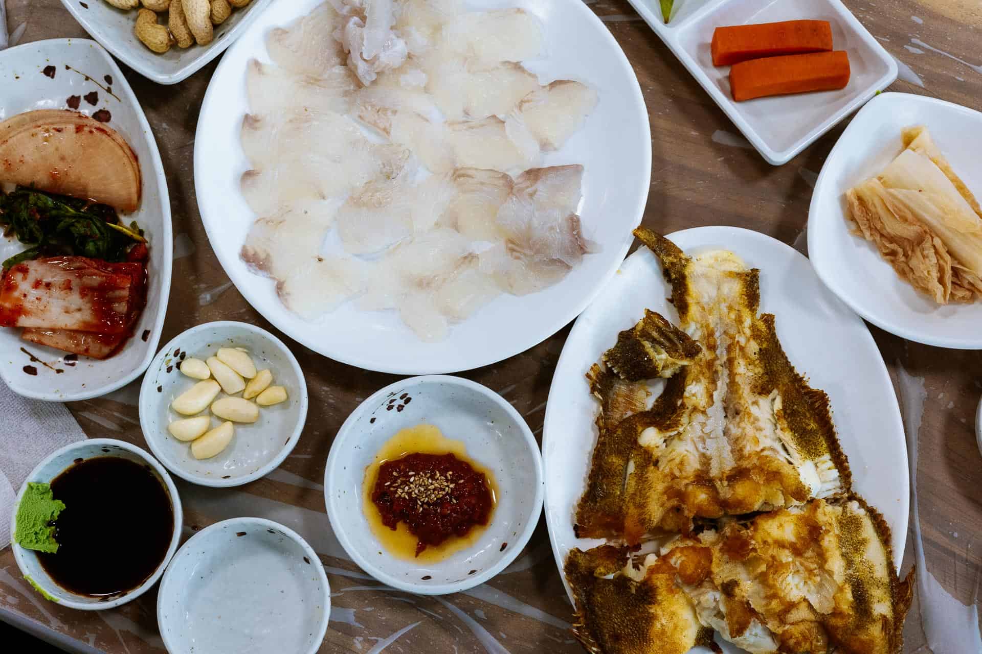 Fried fish, raw fish, and banchan at Jagalchi Market restaurant