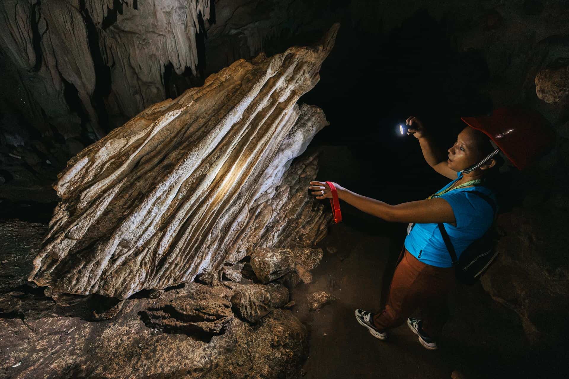 Guide showing rock in Princess Manan-aw Cave in Bohol, Philippines