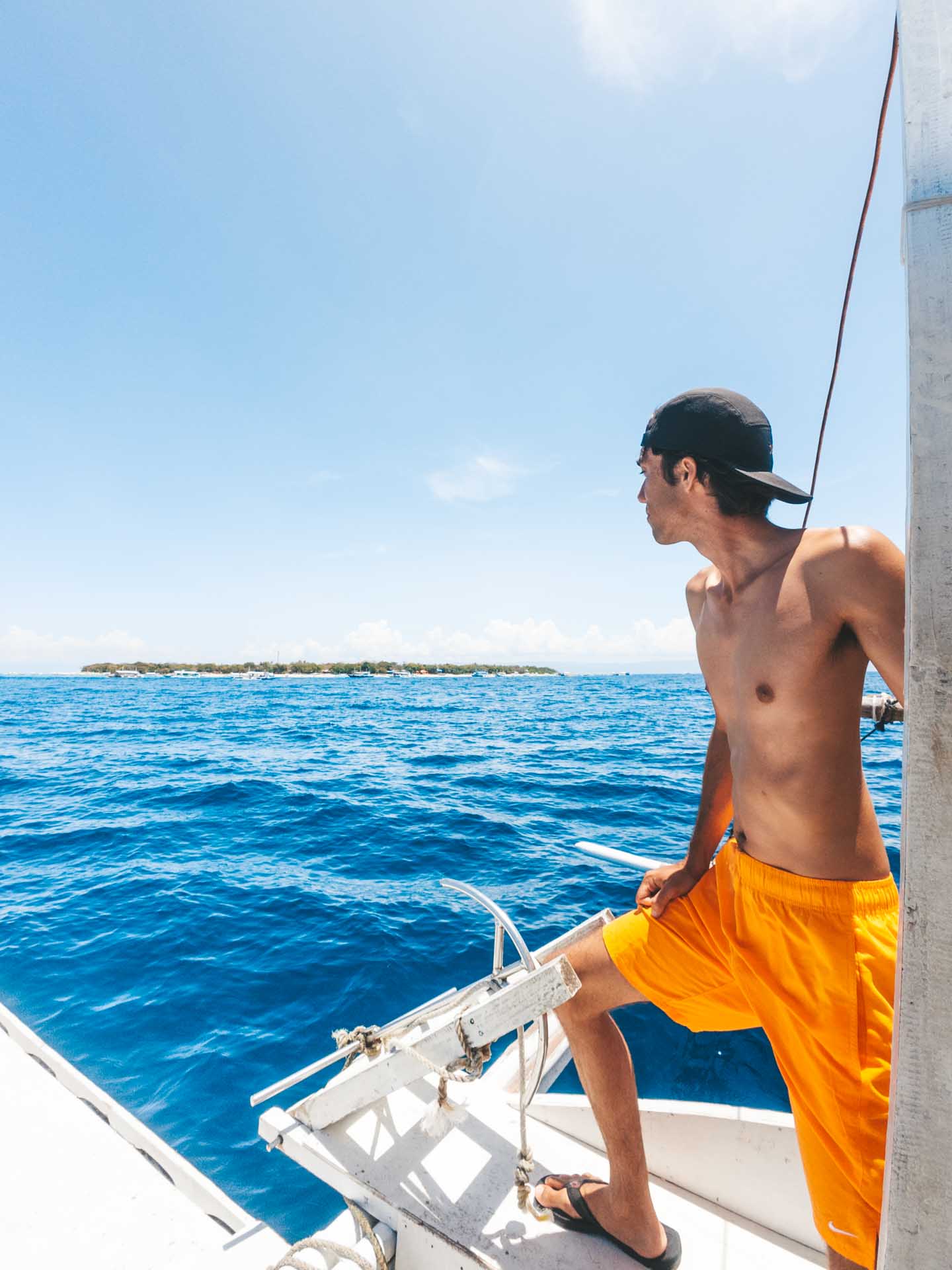 Balicasag Island Snorkeling: Is It Worth It? 3 Man on boat to Balicasag Island
