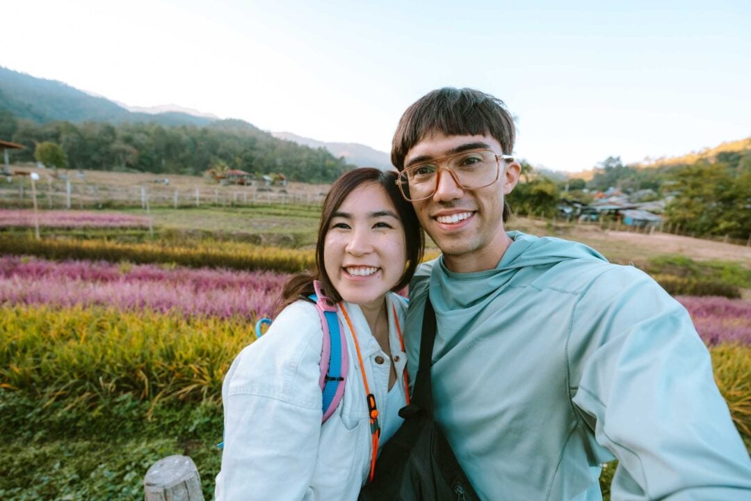 Chloe and Trey in front of rainbow rice at bamboo bridge Pai