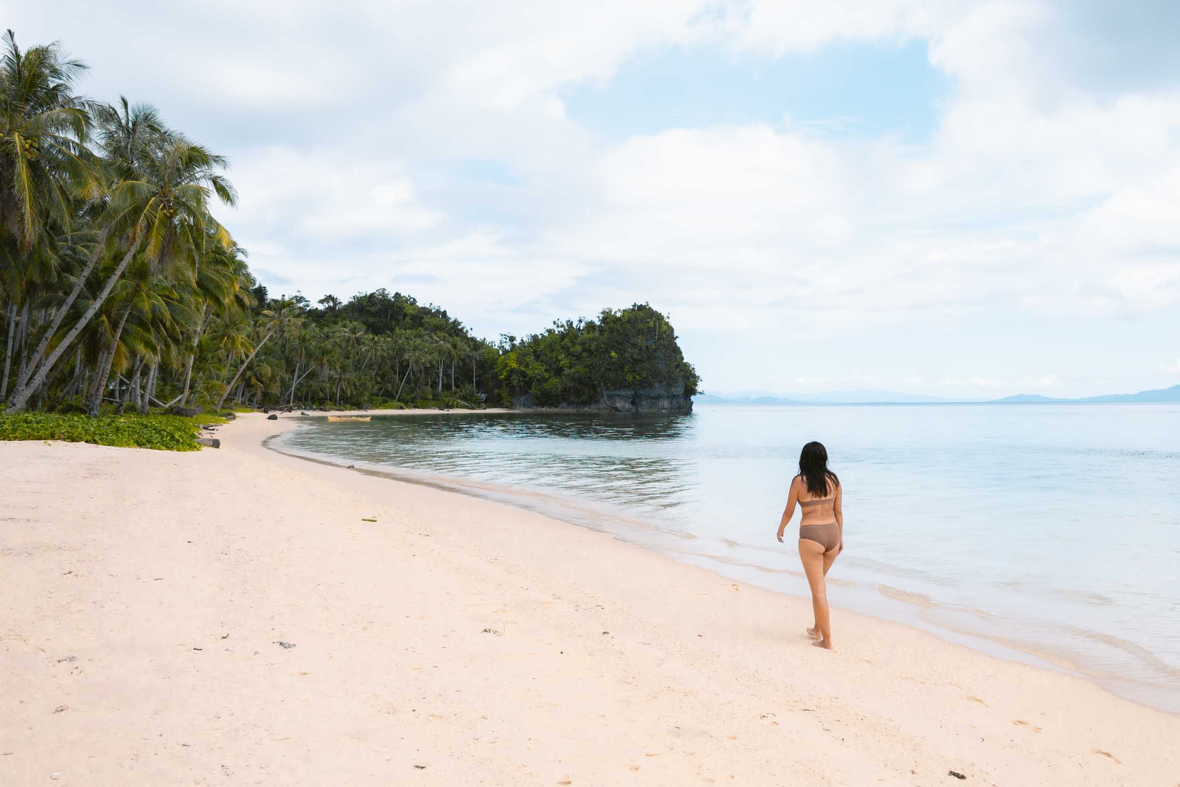 Girl walkong on Pamomoan Beach Siargao
