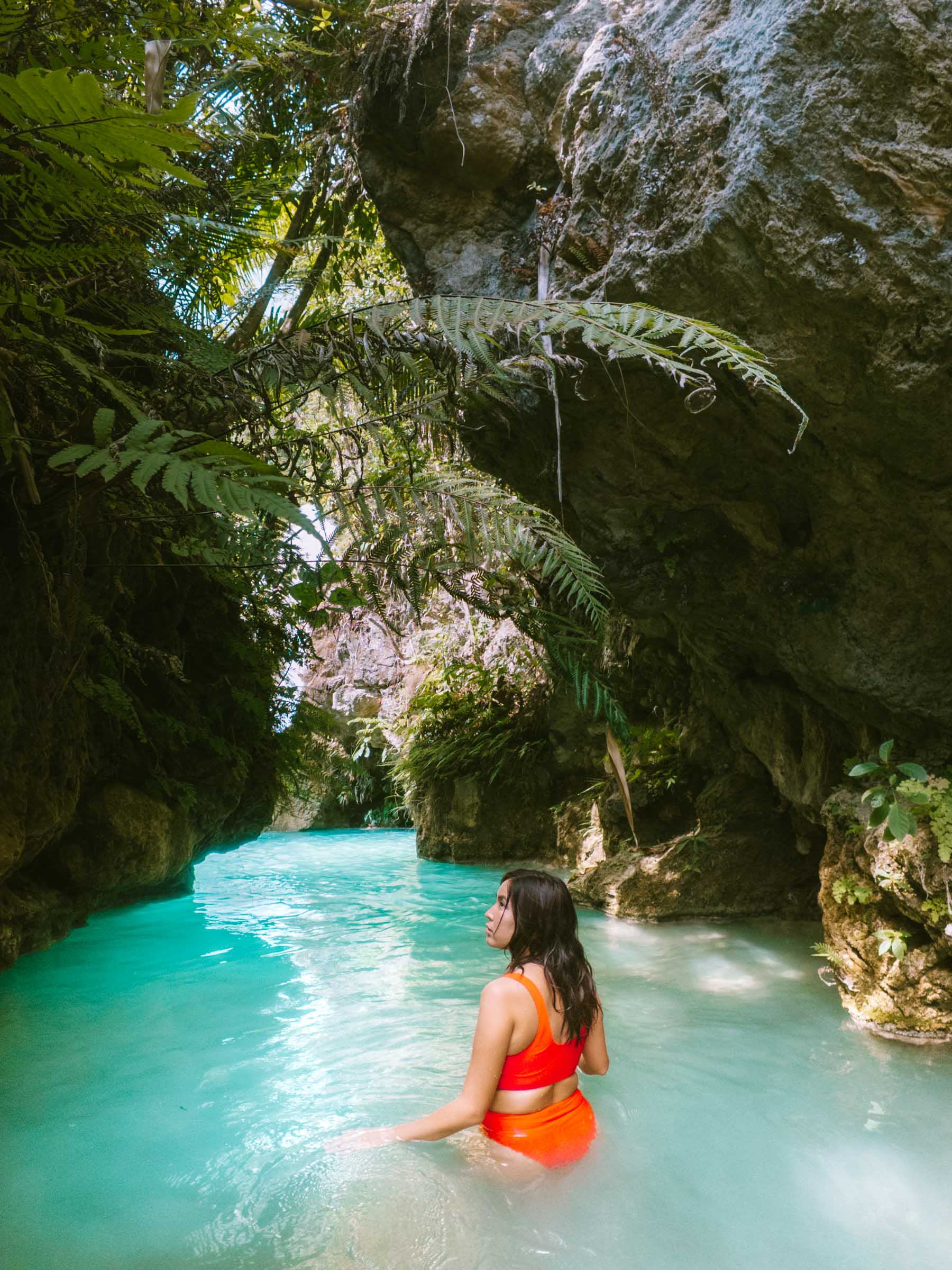 girl exploring inambakan falls cebu waterfall cave