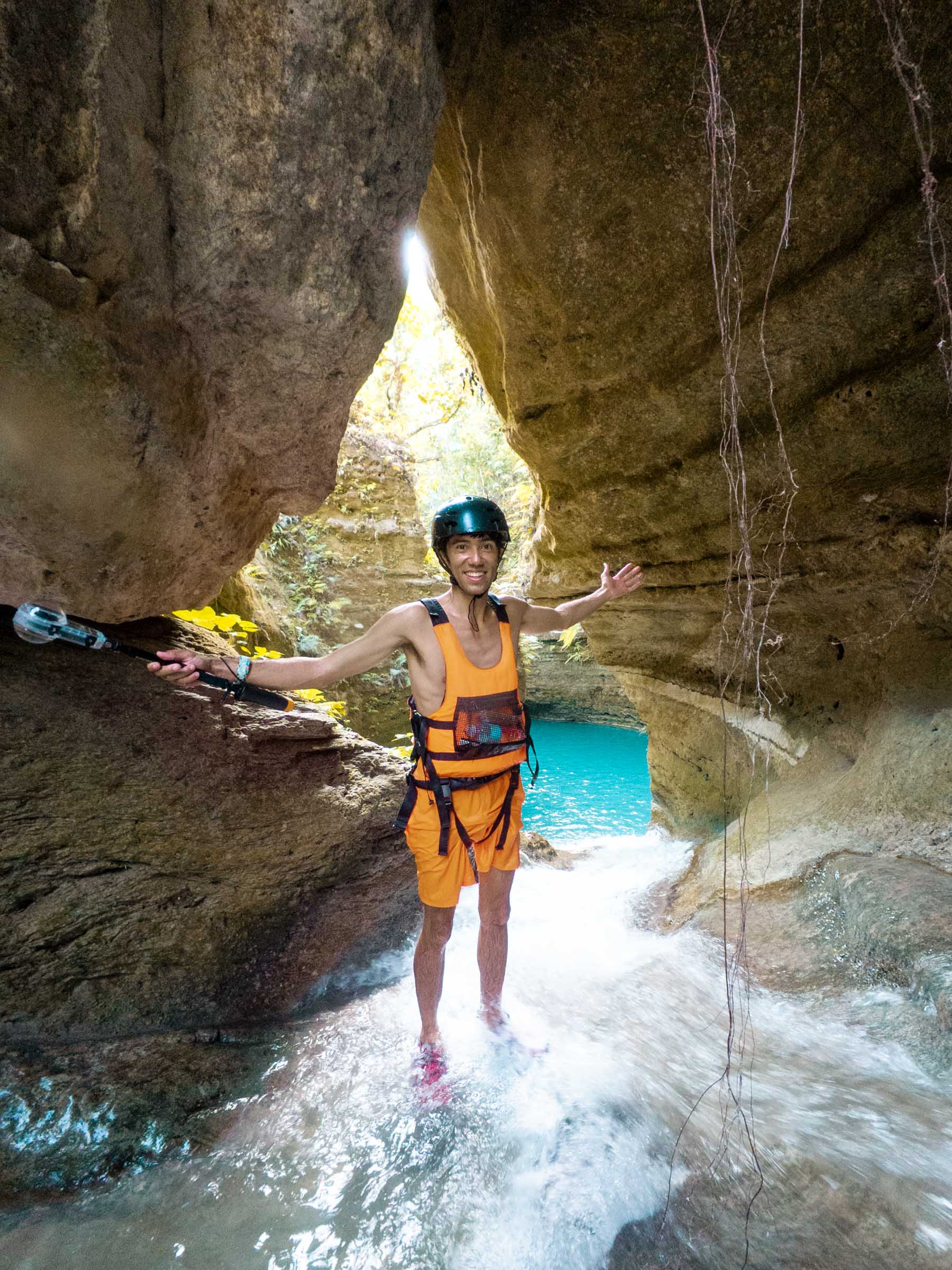 Kawasan Falls Canyoneering: Complete Guide 14 Trey standing at water slide at Kawasan Falls Canyoneering