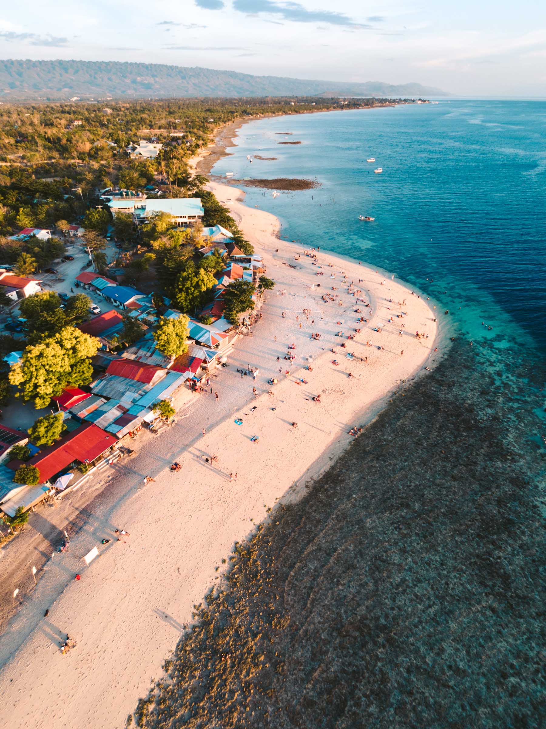 Sunset aerial view of White Beach Moalboal