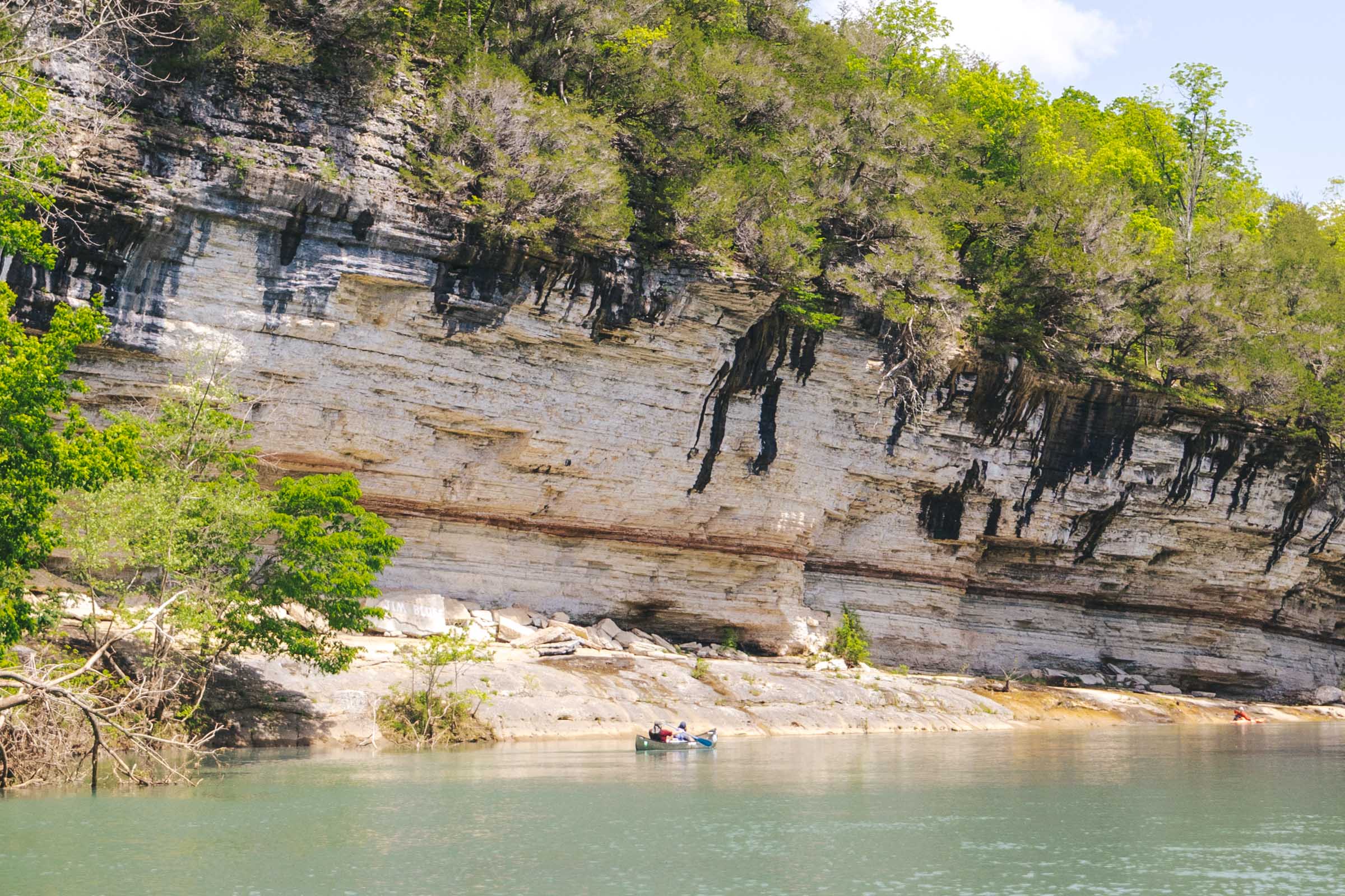 How to Float the Buffalo River in Arkansas: Complete Guide 31 Passing a bluff while floating the Buffalo River in a canoe
