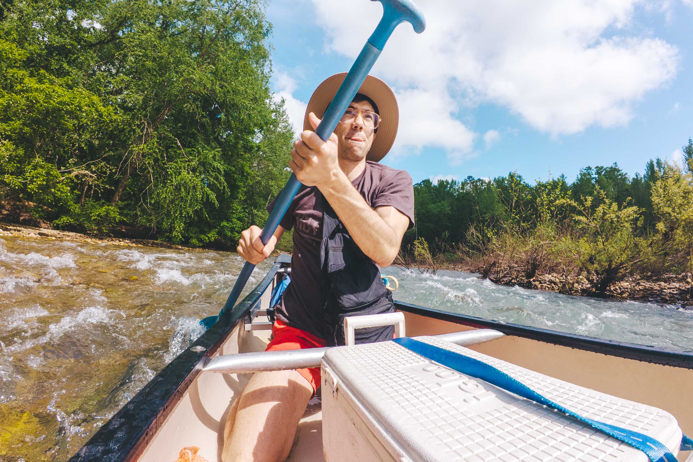 How to Float the Buffalo River in Arkansas: Complete Guide 16 Trey navigating river rapids kneeling down for low center of gravity