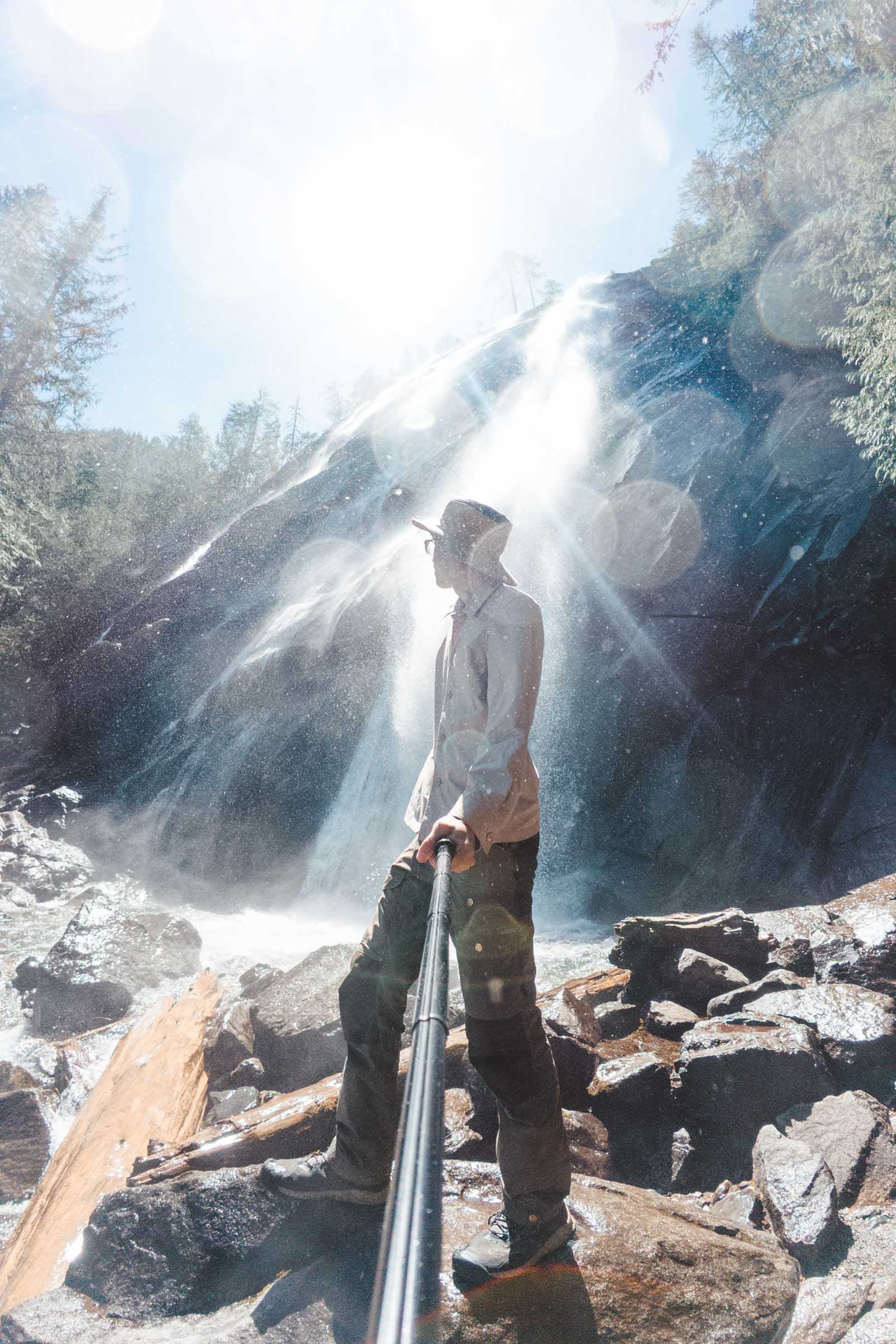 Trey getting sprayed by mist of Bridal Veil Falls